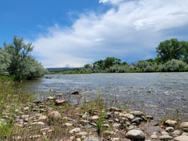 Sign reading 'No Trespassing: Private Property' near a Colorado fishing spot.