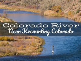 Fly fisherman casting on the Upper Colorado River at the Pumphouse Recreation Area, surrounded by scenic canyon walls and clear, flowing water.