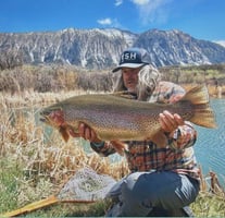 Jeff of West Slope Fly Fishing holds up a monster Rainbow Trout. 