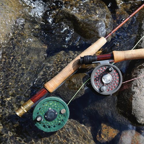 two fly rods rest on the bank of the south platte river near deckers colorado on the south platte river a fly fishing spot near denver colorado