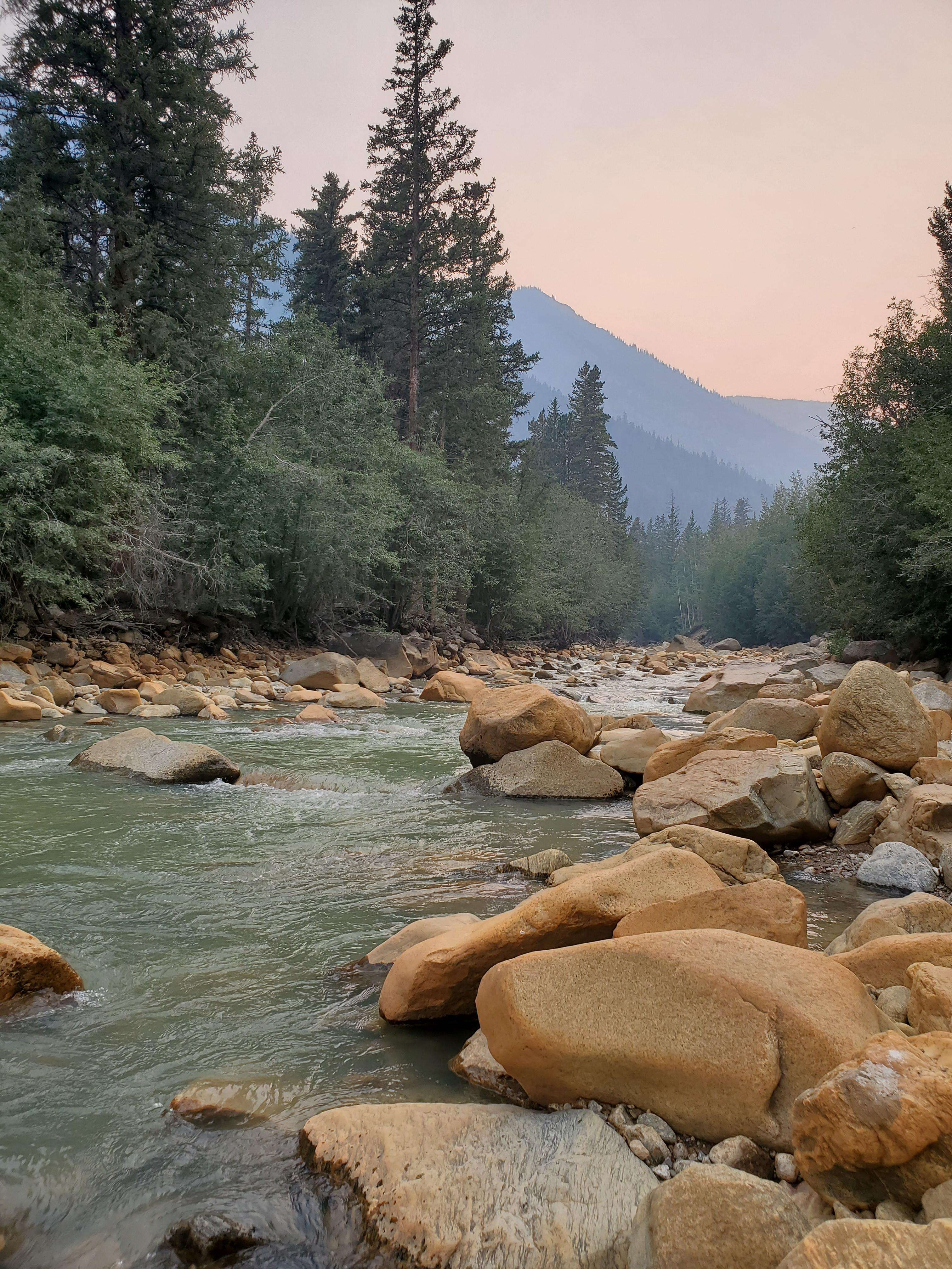 colorado high mountain stream outside of Aspen Colorado during a terrible wildfire. The skies are covered in smoke bu the beauty of colorado remains. 