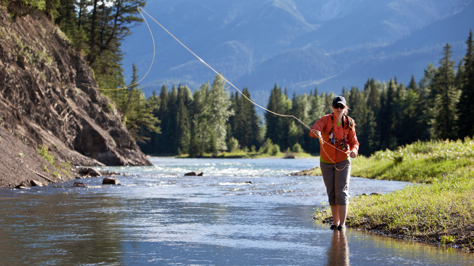 a woman casting on the colorado river near rocky mountain national park