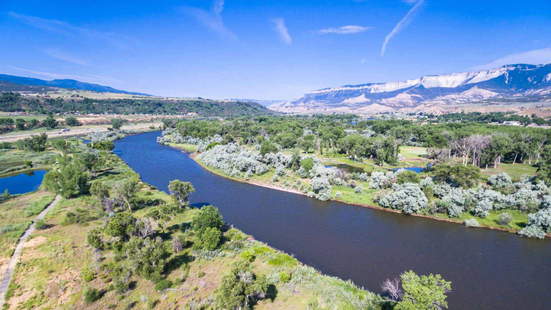 Colorado River At Rifle with i-70 and the Book Cliffs in the distance. 