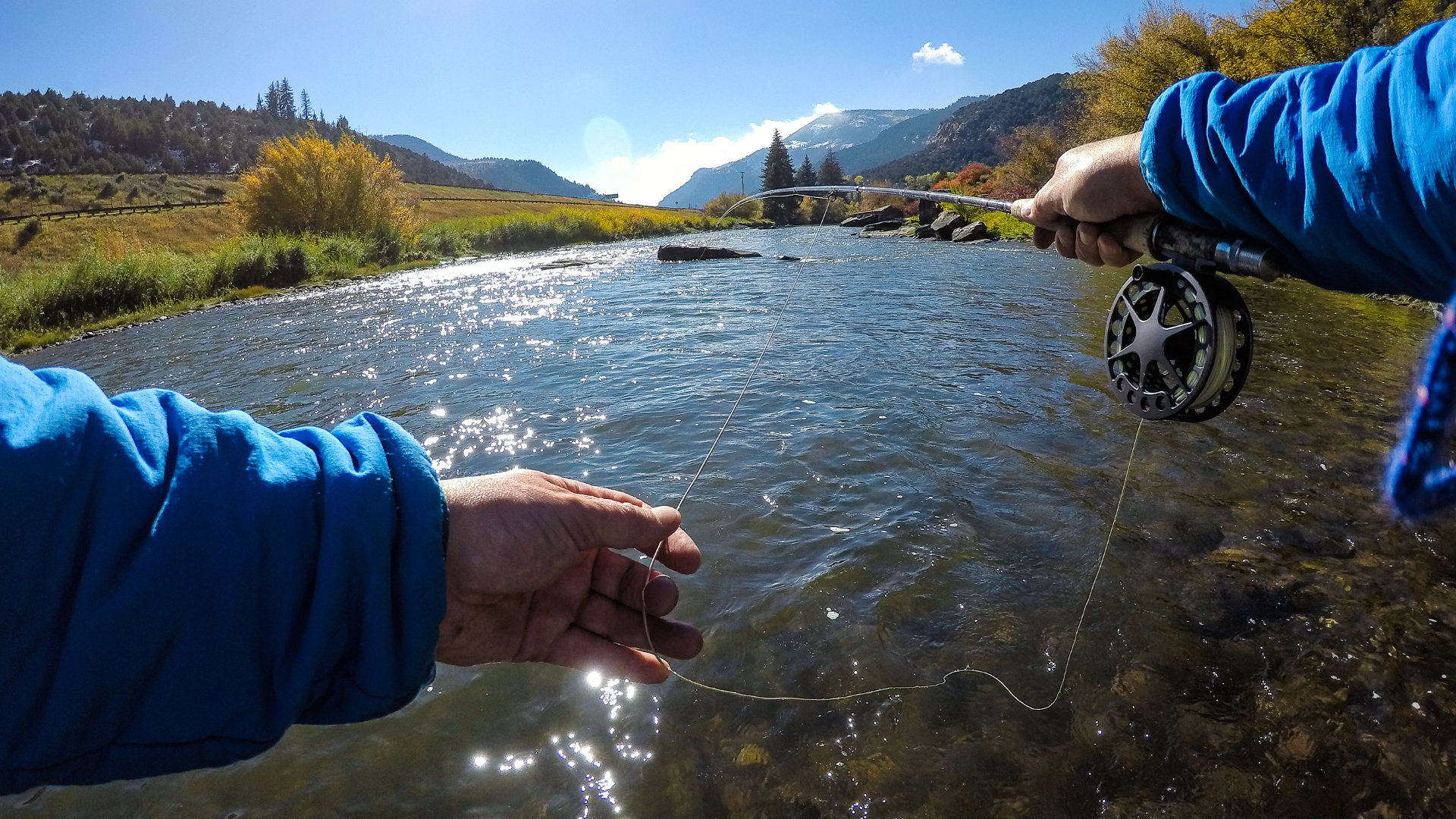Angler wearing breathable waders and boots, standing in a Colorado mountain stream