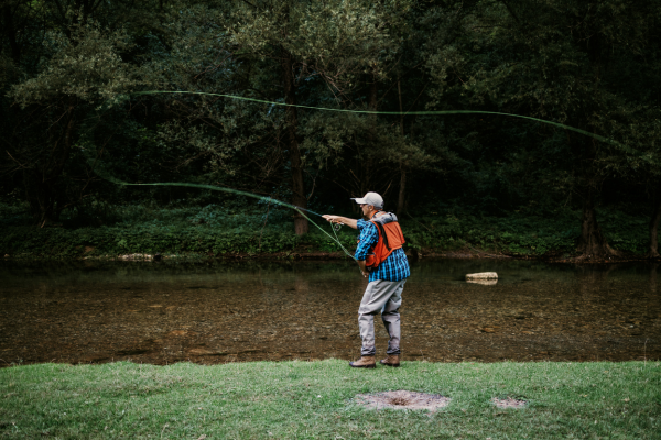 an angler casts a wet fly out to some hungry trout